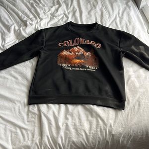 A black sweatshirt with Colorado on it is the size medium